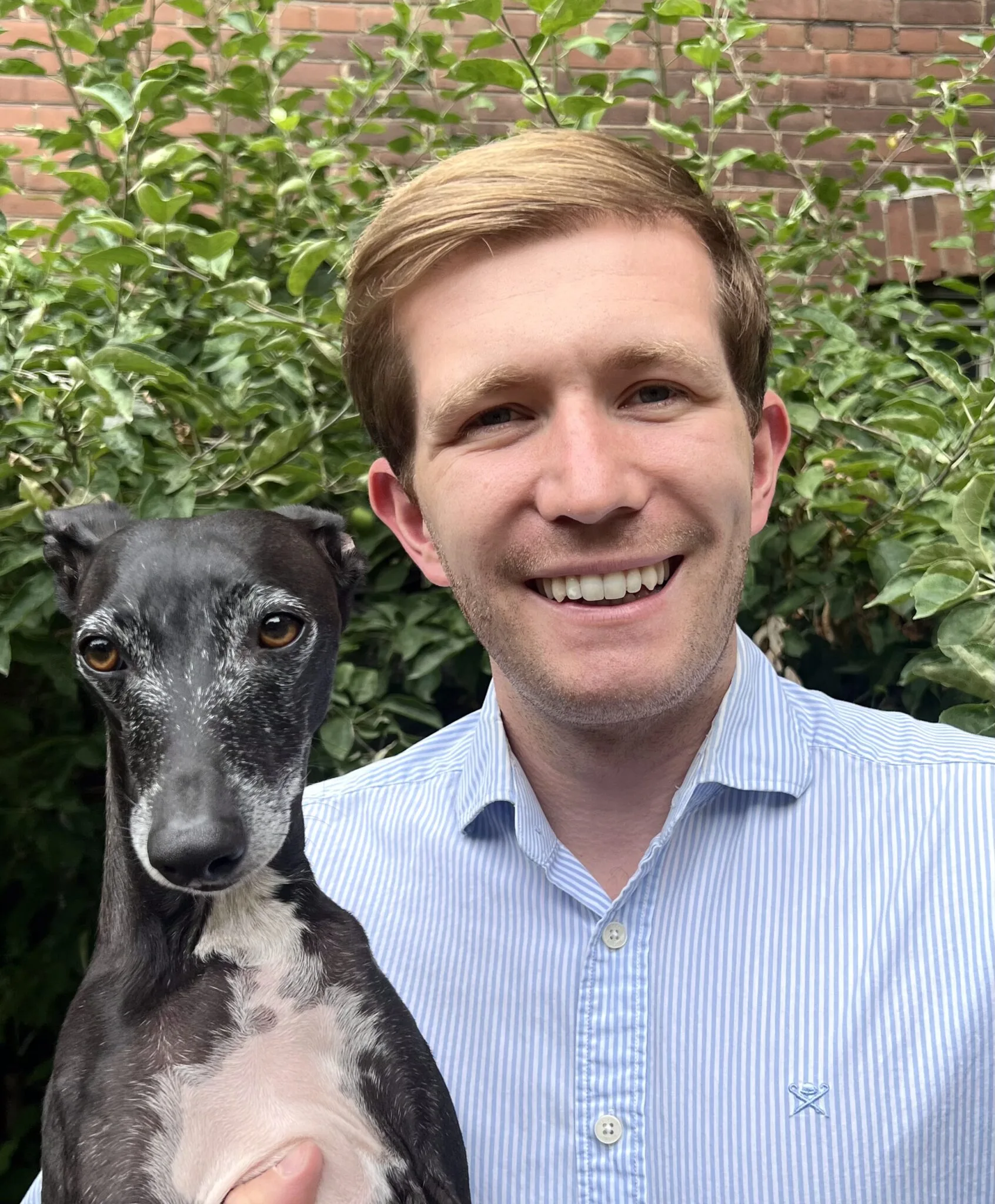 dr brett noden smiling with a dog